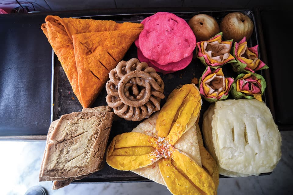 Family celebrating Dashain or Tihar with food from Tohmeal